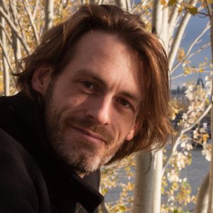 The same autumn portrait of Dirk Primbs among birch trees, cropped square.